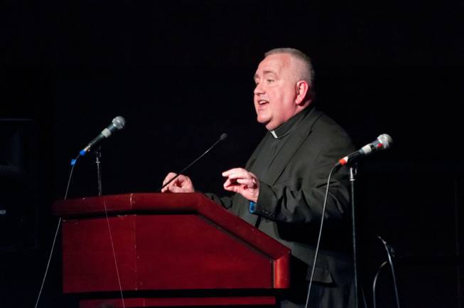 Rev. Robert Stoeckig, Vice General of the Catholic Diocese of Las Vegas, addresses about 1,500 valley residents who gathered to address community and family concerns, May 22, 2012. Members of local Christian, Jewish and Muslims organizations, along with other charitable and non-profit groups, addressed issues such as children's safety, foreclosures, immigration, and education.